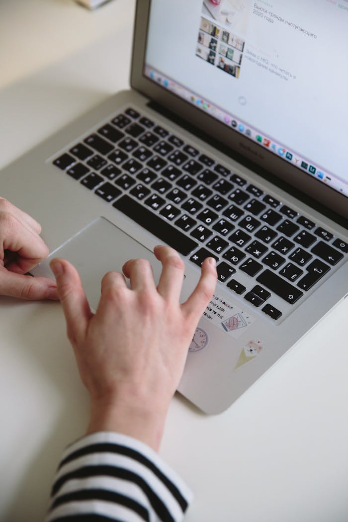 A woman uses a laptop in a home office setting, perfect for remote work and freelance projects.